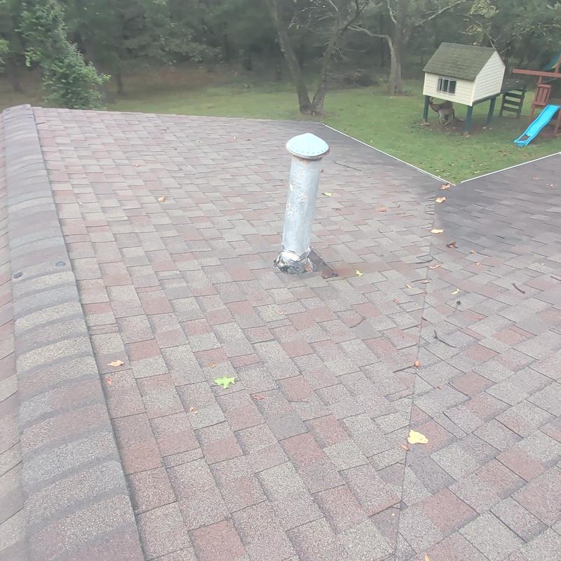 Asphalt shingle roof with vent pipe flashing