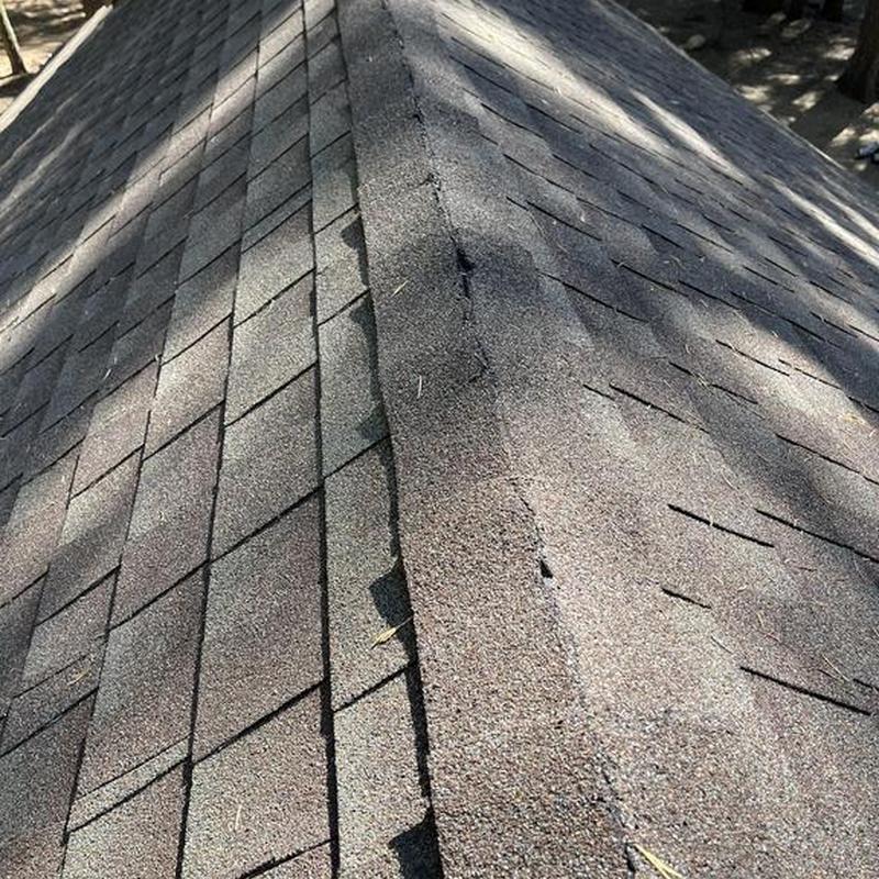 Asphalt shingle roof ridge on cabin in Camp Connell