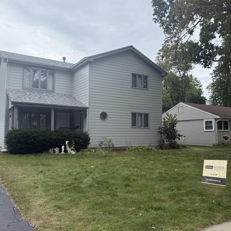 Insulated composite siding with soffit and fascia on house