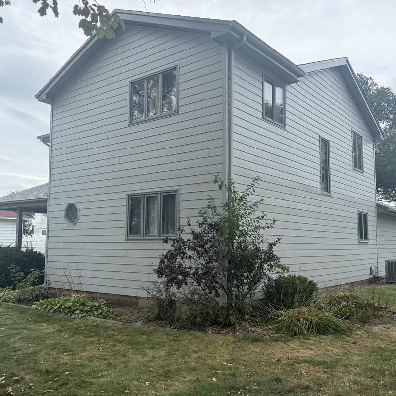 Insulated composite siding with soffit and fascia panels