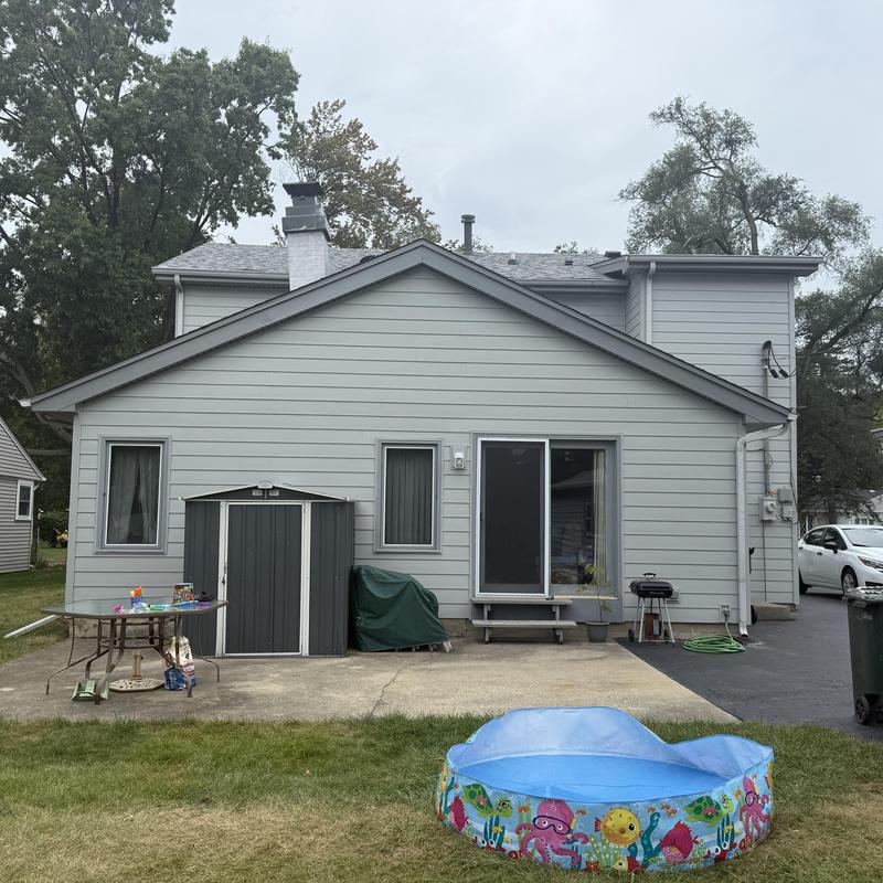 Insulated composite siding with soffit and fascia