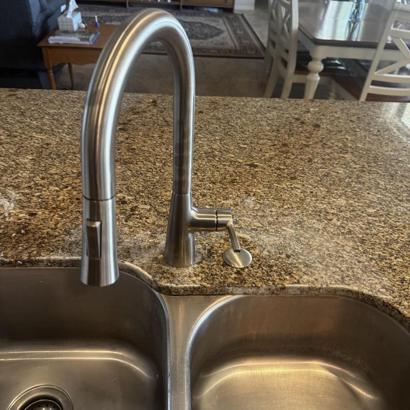 Brushed-nickel kitchen faucet on granite countertop Brushed-nickel kitchen faucet on granite countertop