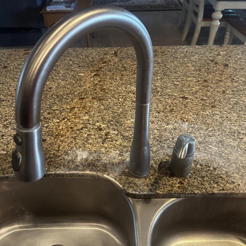 Brushed-nickel kitchen faucet on granite countertop Brushed-nickel kitchen faucet on granite countertop
