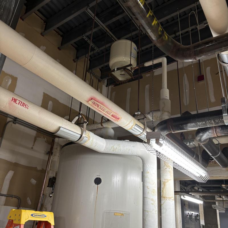 13.5-gallon expansion tank above holding tank with pipes 13.5-gallon expansion tank above holding tank with pipes