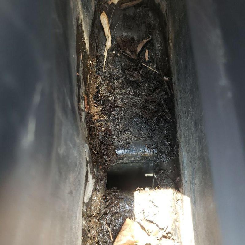 Gutter interior with debris and dirt buildup Gutter interior with debris and dirt buildup