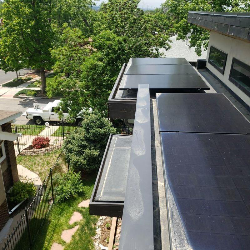 Gutter system with solar panels on flat roof Gutter system with solar panels on flat roof