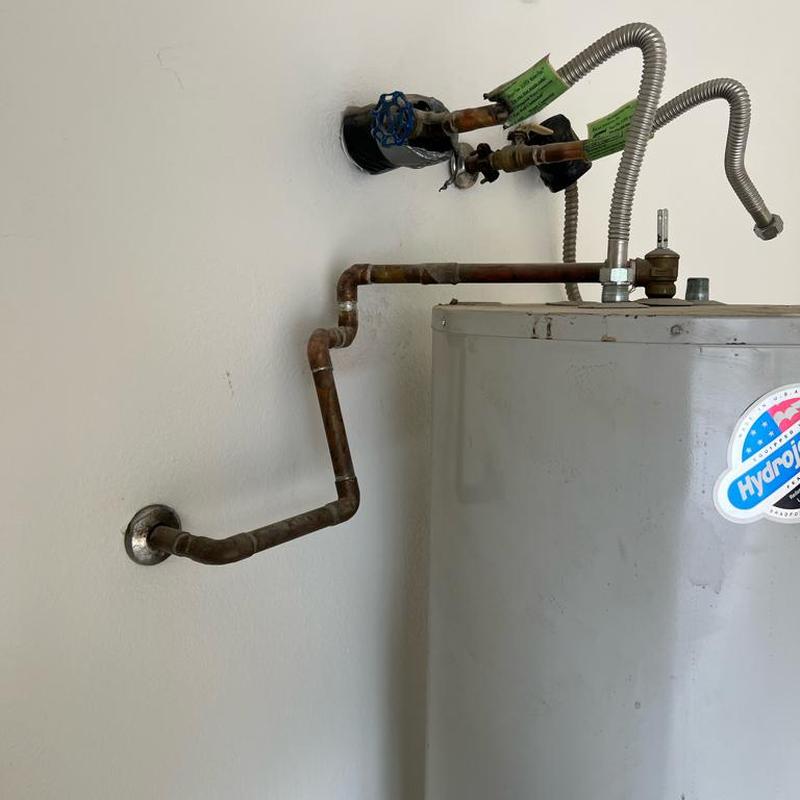Electric water heater supply and discharge piping installation