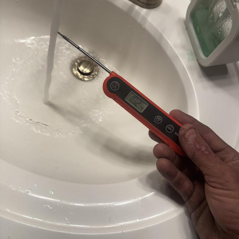 Water temperature testing with digital thermometer in sink Water temperature testing with digital thermometer in sink