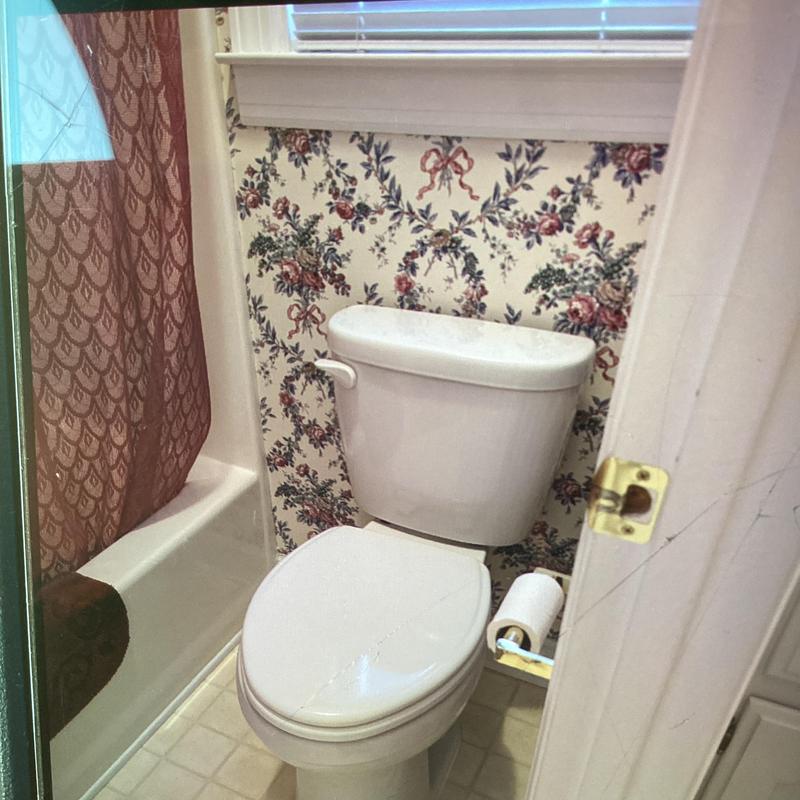 Elongated white toilet with wood seat installation Elongated white toilet with wood seat installation