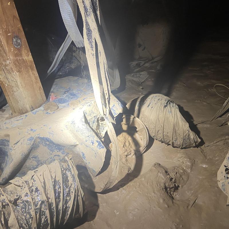 Ductwork damaged by flood in crawlspace with mud