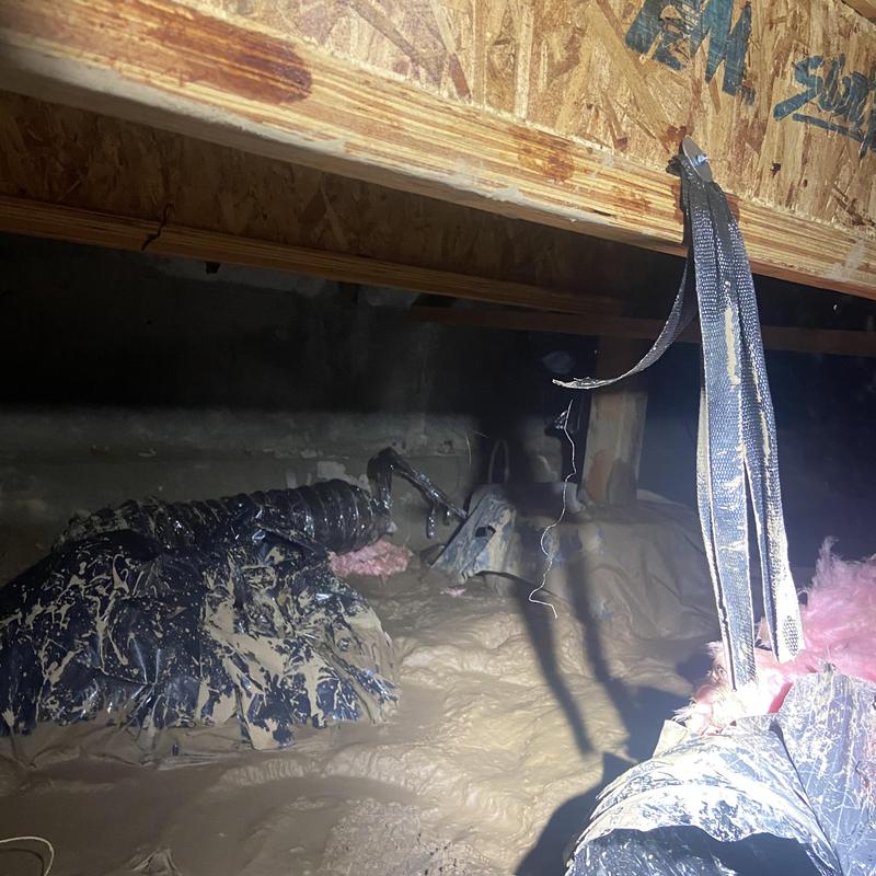 Ductwork in flooded crawlspace covered in mud