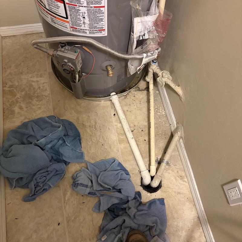 Water heater with connected drain and supply pipes Water heater with connected drain and supply pipes
