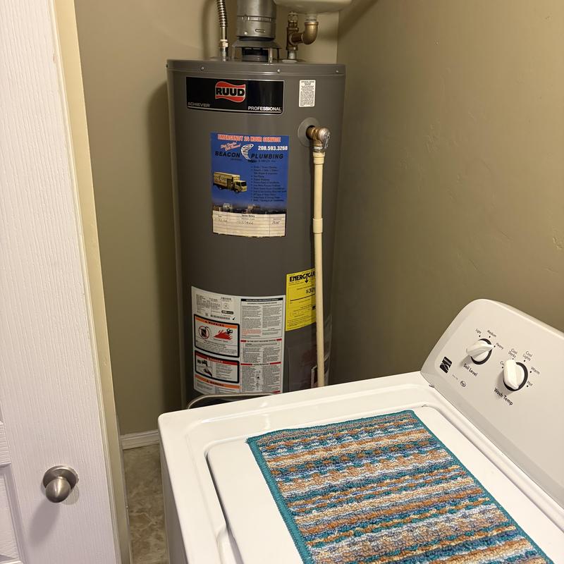 Water heater installation with plumbing inspection in laundry room Water heater installation with plumbing inspection in laundry room