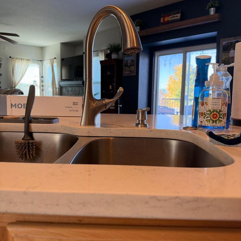 Kitchen faucet with soap dispenser on countertop