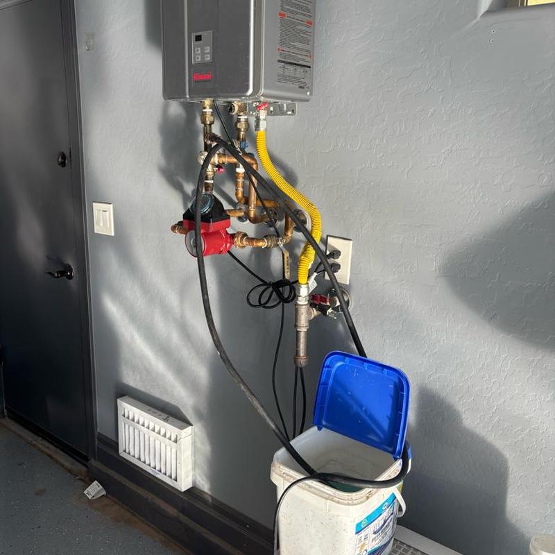 Tankless water heater flushing setup with bucket