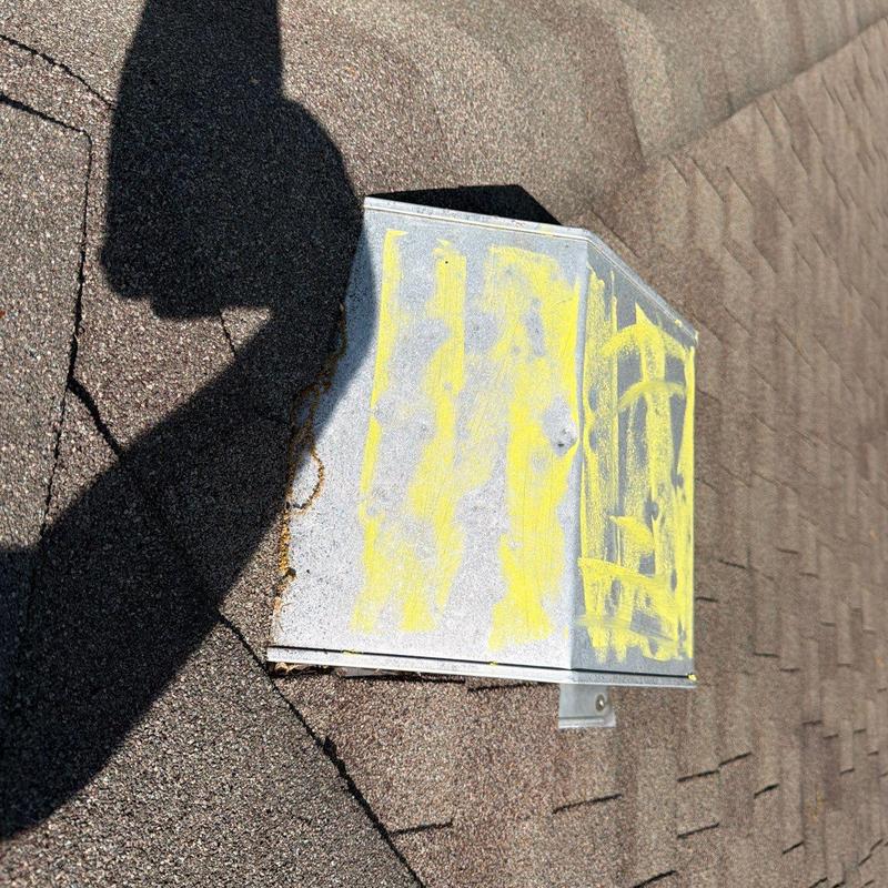 Roof vent with hail damage marking on shingles