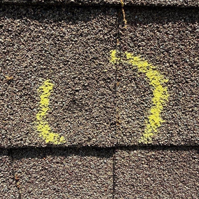 Asphalt shingles with yellow hail damage marking