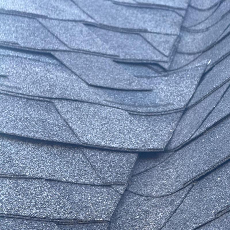 Asphalt roof shingles close-up showing hail damage