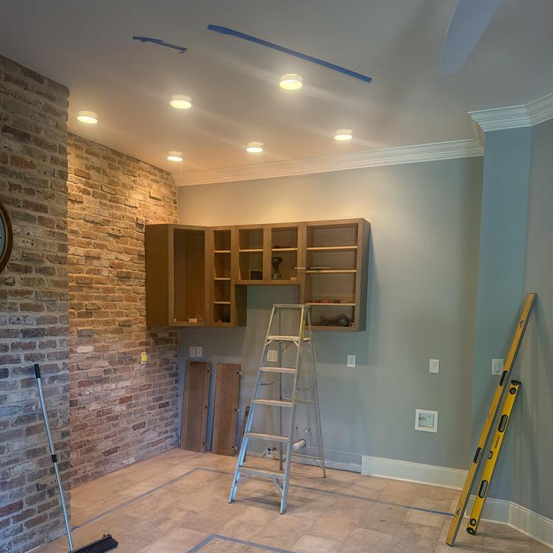 Kitchen cabinetry installation with ladder and tools Kitchen cabinetry installation with ladder and tools