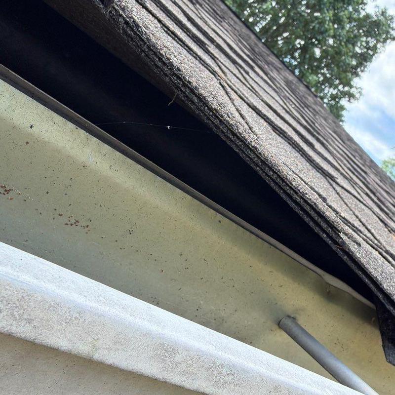 Roof shingles and metal flashing closeup on roof edge