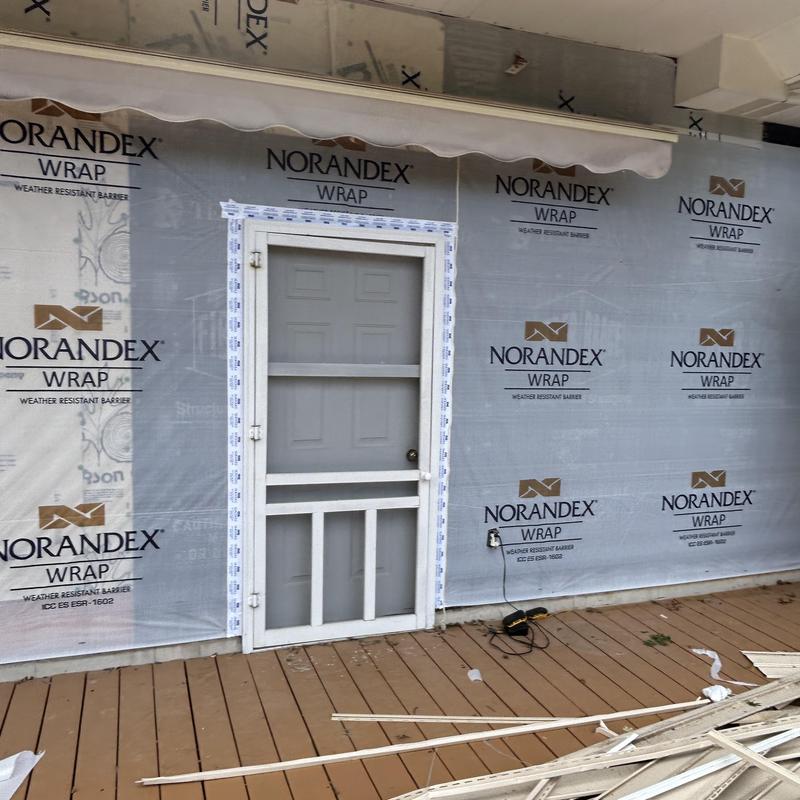 Vinyl siding removal with Norandex wrap installation