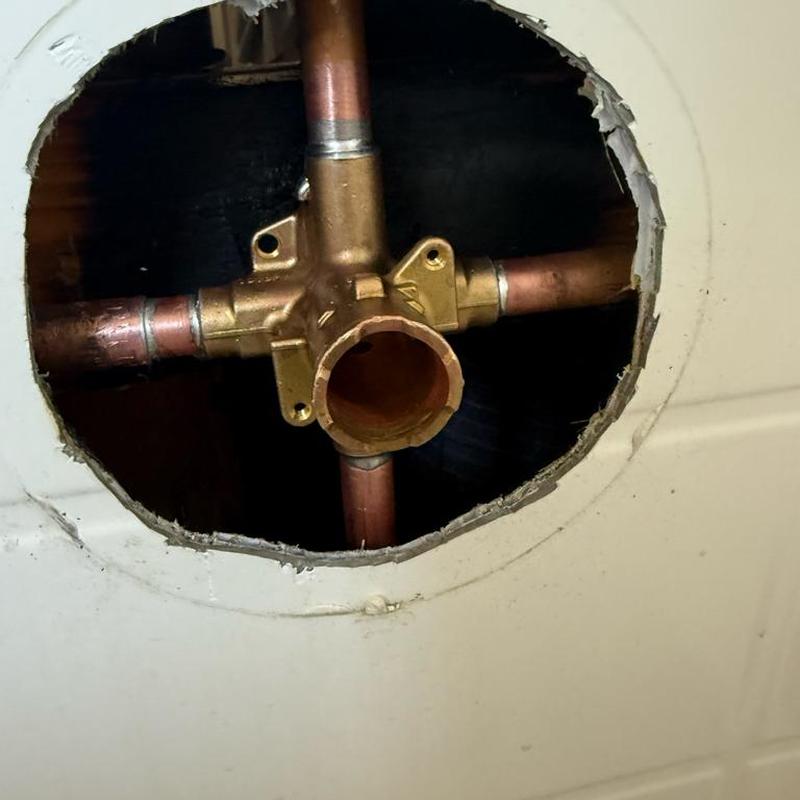 Shower valve housing and copper piping inside wall cavity