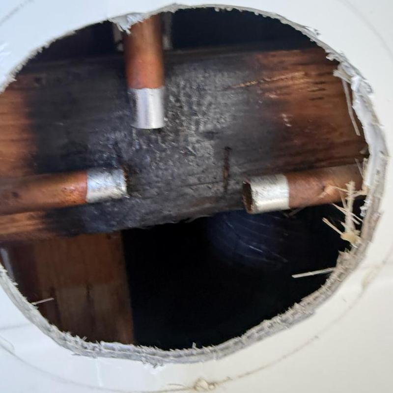 Shower valve copper piping behind drywall cutout