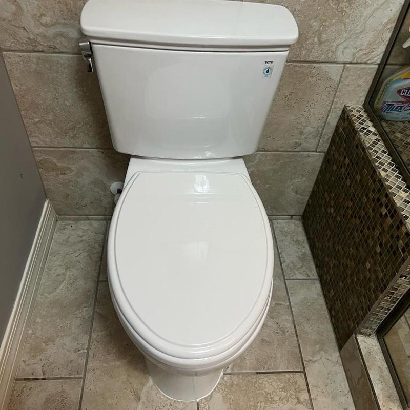 Toto toilet installation with sealed base in bathroom