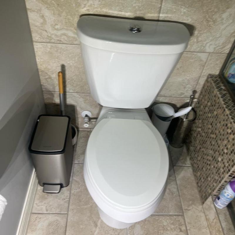 Toilet installation with new wax ring and caulking