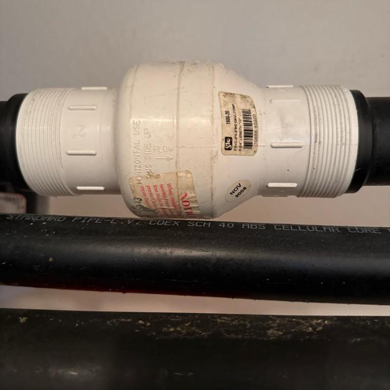 Swing check valve on basement pump line