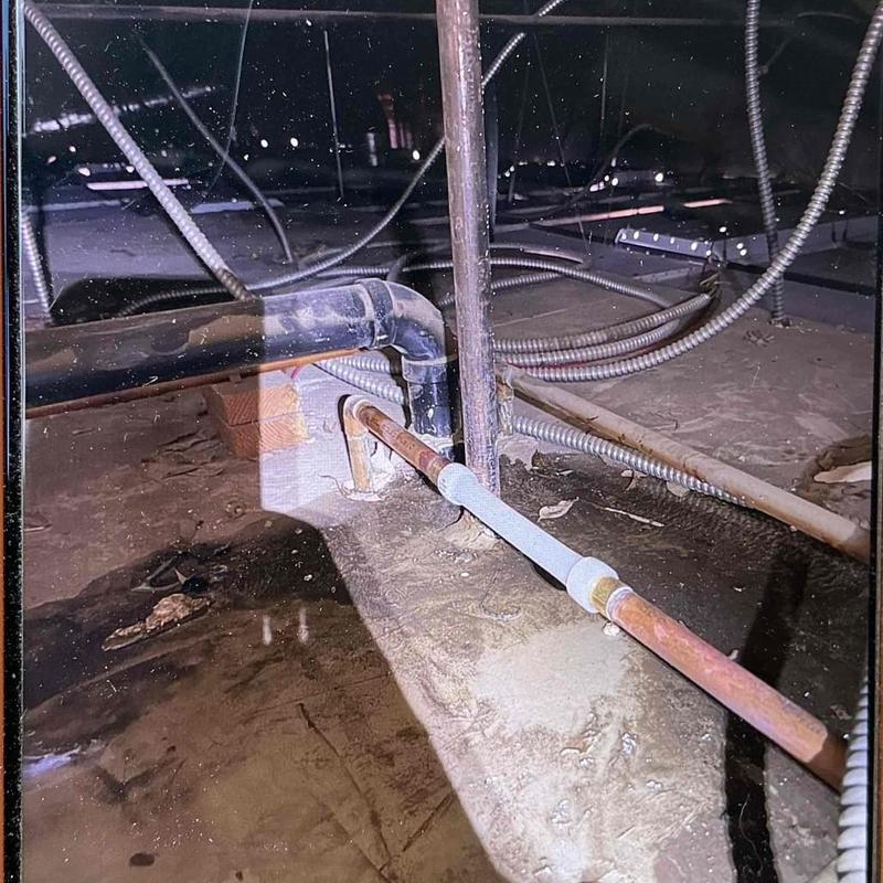 Copper pipe with PEX-to-copper adapter soldered in crawl space