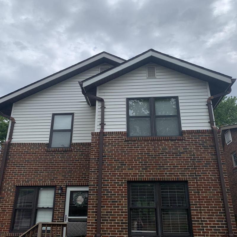 Vinyl siding and brick exterior with storm damage repairs