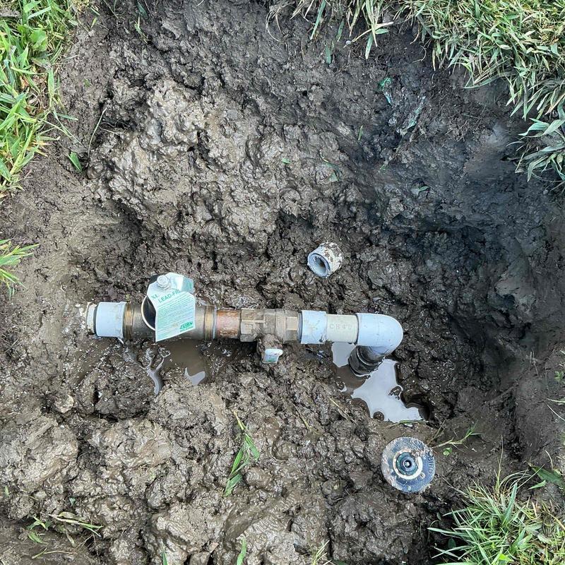 Water shutoff valve with new fittings in muddy ground