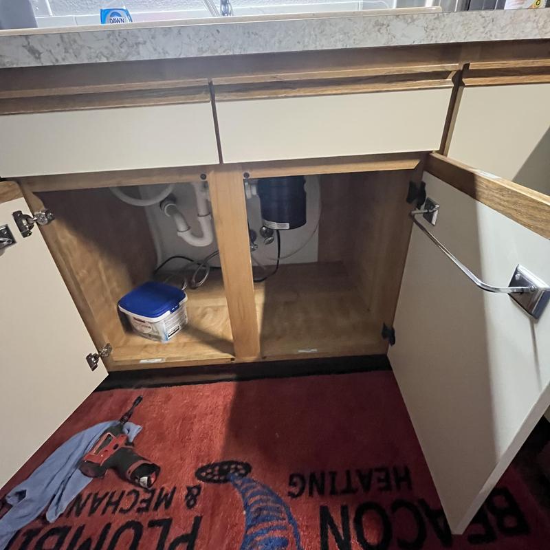Garbage disposal and strainer installation under sink