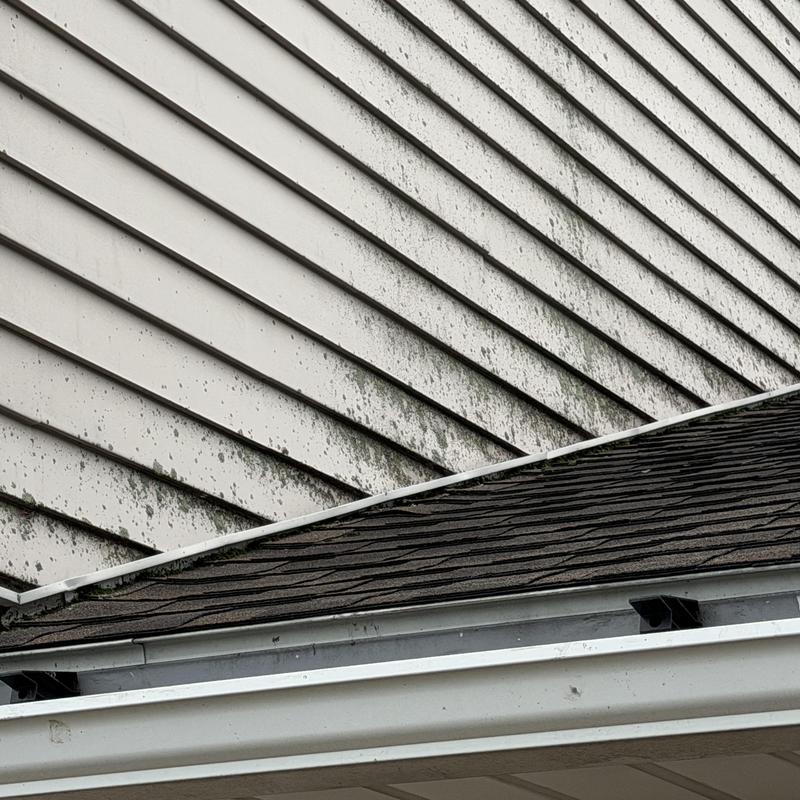 Roof-to-wall flashing with stained vinyl siding Roof-to-wall flashing with stained vinyl siding