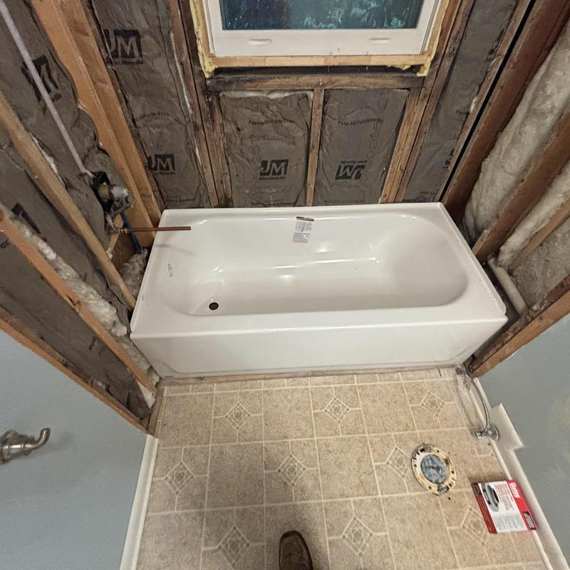 Bathroom bathtub installation with exposed wall framing Bathroom bathtub installation with exposed wall framing