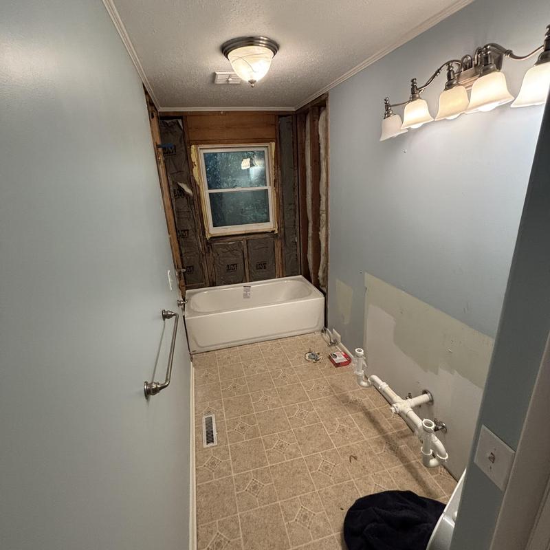 Bathtub installed, wall and plumbing prep in bathroom Bathtub installed, wall and plumbing prep in bathroom