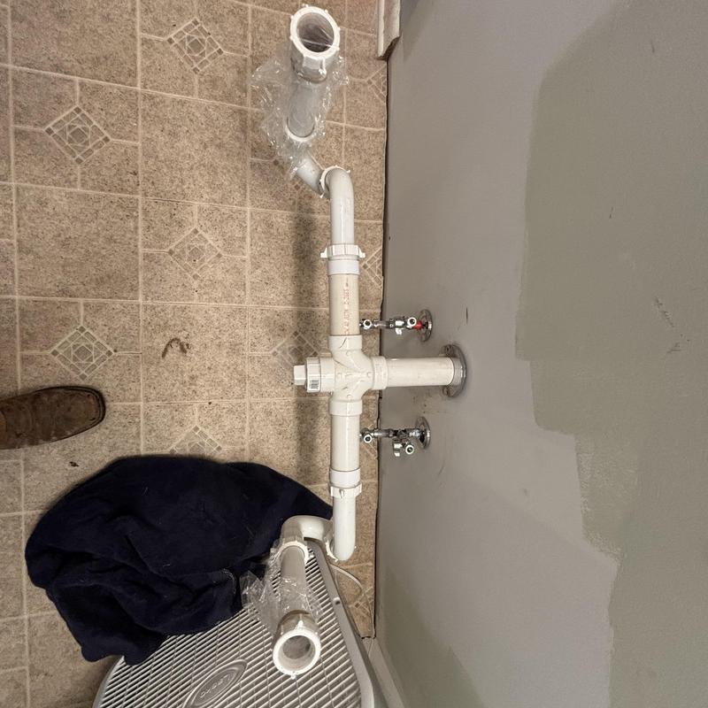 PVC drain and shut-off valves with supply lines installed PVC drain and shut-off valves with supply lines installed