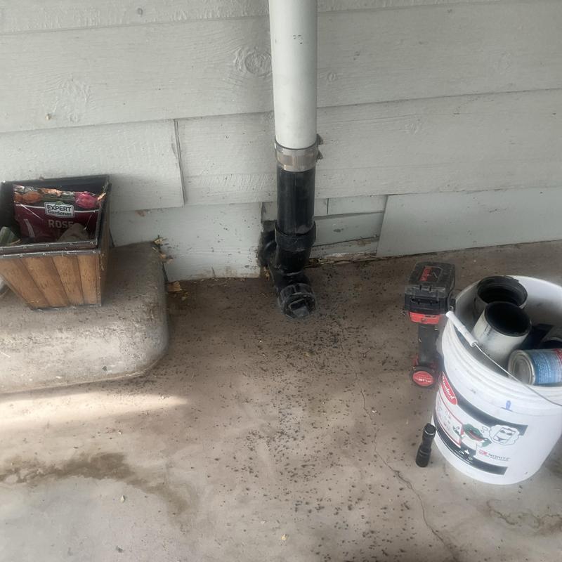 Main sewer pipe cleanout installation with tools nearby