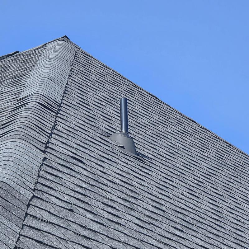 Hip and ridge shingles with vent pipe on roof Hip and ridge shingles with vent pipe on roof