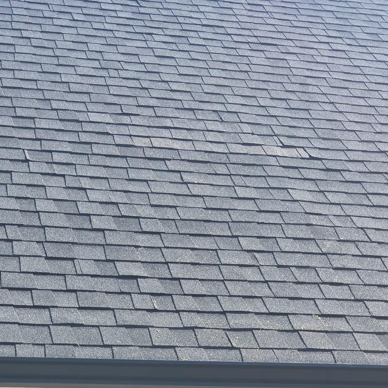 Architectural asphalt roof shingles on residential roof Architectural asphalt roof shingles on residential roof