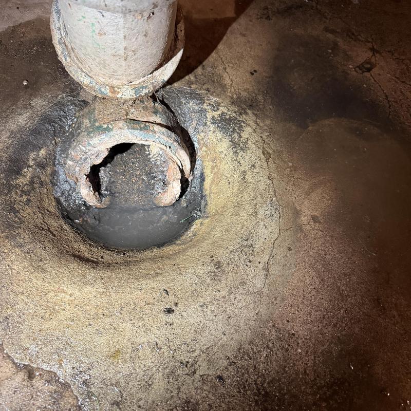 Cast iron main sewer pipe with corrosion and hole Cast iron main sewer pipe with corrosion and hole