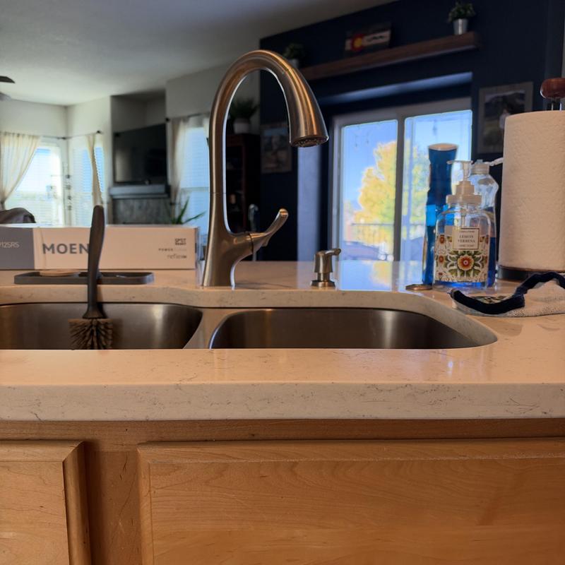 Kitchen faucet with soap dispenser on countertop