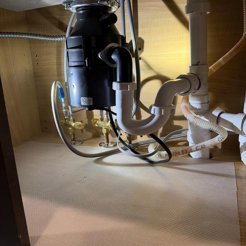 Garbage disposal and sink drain plumbing under cabinet