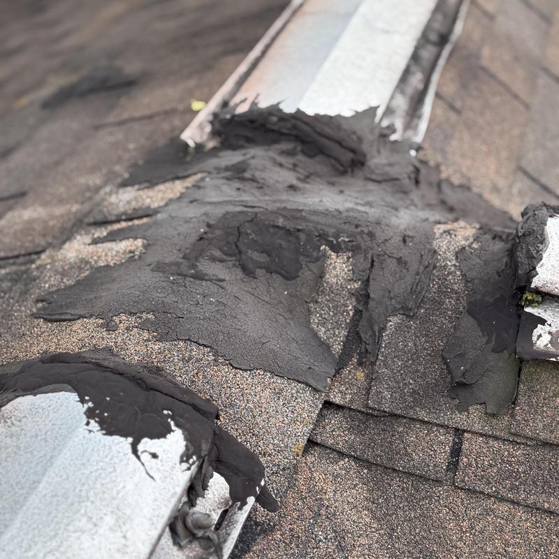 Rolled roofing with deteriorating roof cement patches Rolled roofing with deteriorating roof cement patches