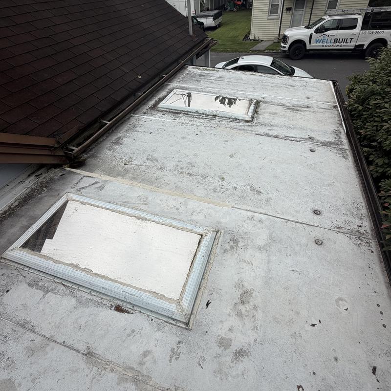 Rolled roofing with skylight and roof leak signs Rolled roofing with skylight and roof leak signs
