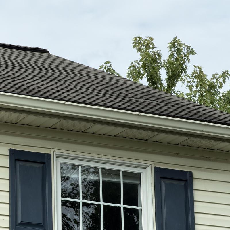 Asphalt shingle roof with missing tabs and damage Asphalt shingle roof with missing tabs and damage