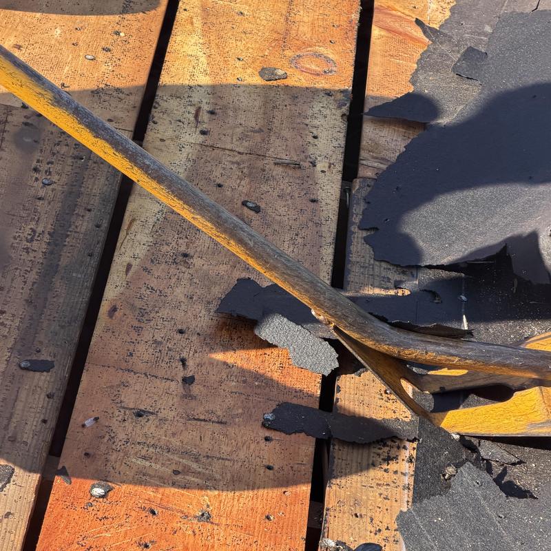 Wood plank roof decking with damaged shingles removed Wood plank roof decking with damaged shingles removed