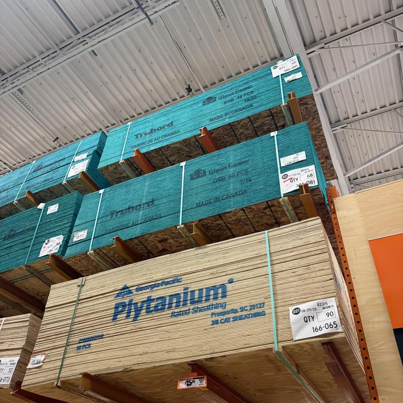 OSB roof sheathing stacked on warehouse shelves OSB roof sheathing stacked on warehouse shelves