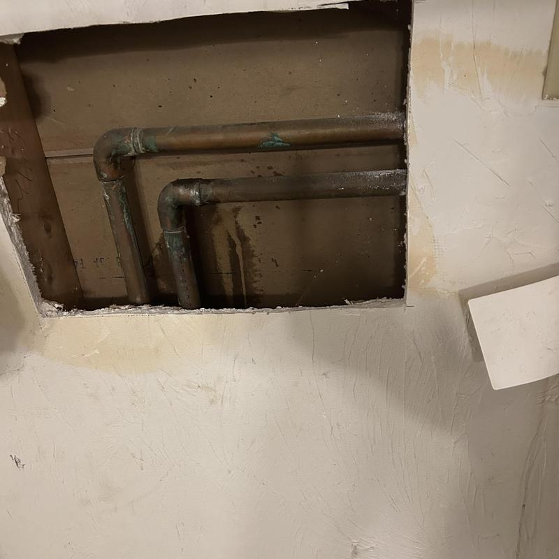 Copper water pipes inside wall damage access cutout Copper water pipes inside wall damage access cutout